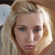 Blue Eyes Blonde With Freckles On Her Face