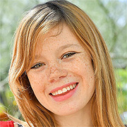 Smiling Freckled Redhead Girl Outside